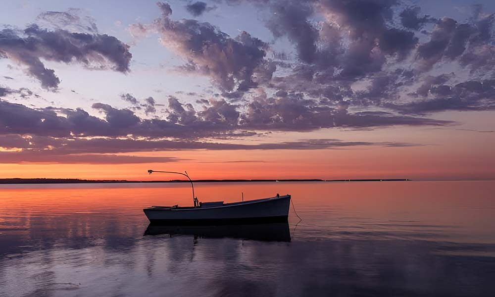 Small boat at sunset